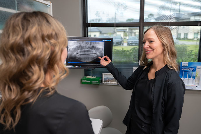 dental staff points to dental xray inside Copperfield Dentistry clinic