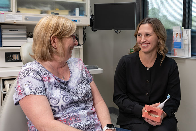 lady patient shares a smile with a dental staff at Copperfield Dentistry