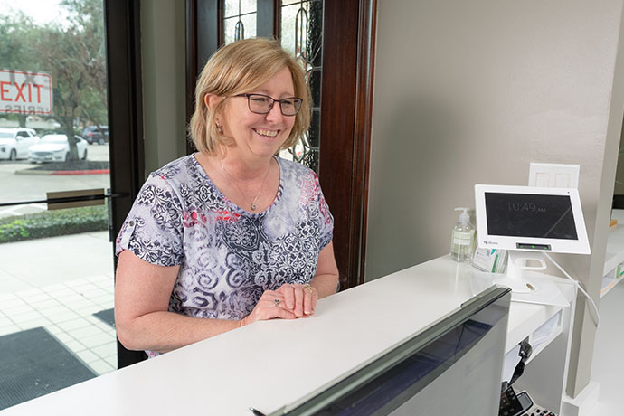 a female guest at the reception of Copperfield Dentistry dental office