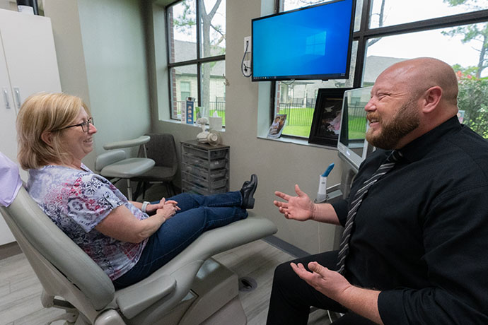 Dr. Jacob A. Burch with patient inside Copperfield Dentistry office in Houston, TX