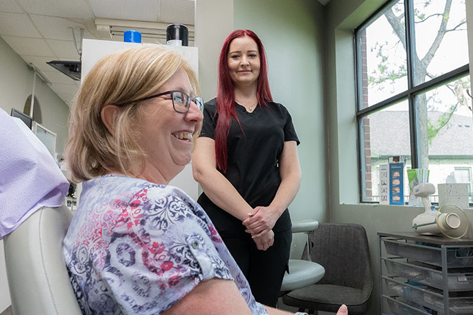 happy patient with staff at copperfield dentistry in Houston, TX